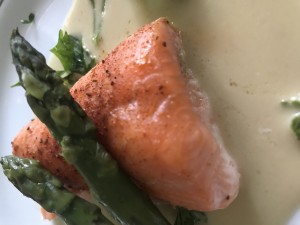 SALMON FILLET GENTLY COOKED THEN GARNISHED WITH PARSLEY AND WHITE WINE, HORSERADISH, AND ANCHOVY SAUCE (BUTTER WITH ANCHOVY EXTRACT AND LEMON PICKLES )